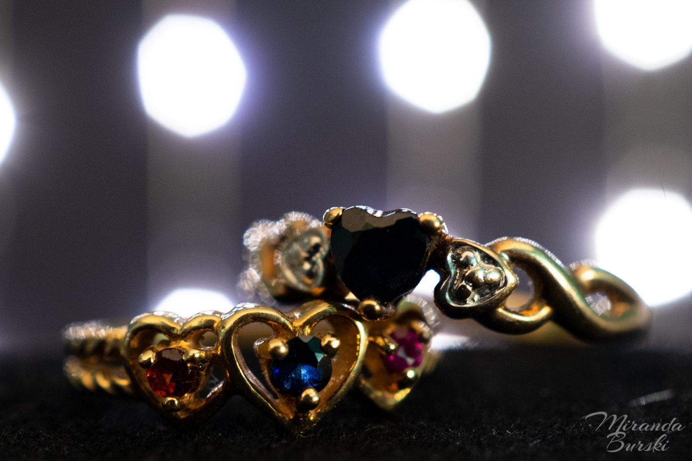 Two gold rings with sapphires and other gems